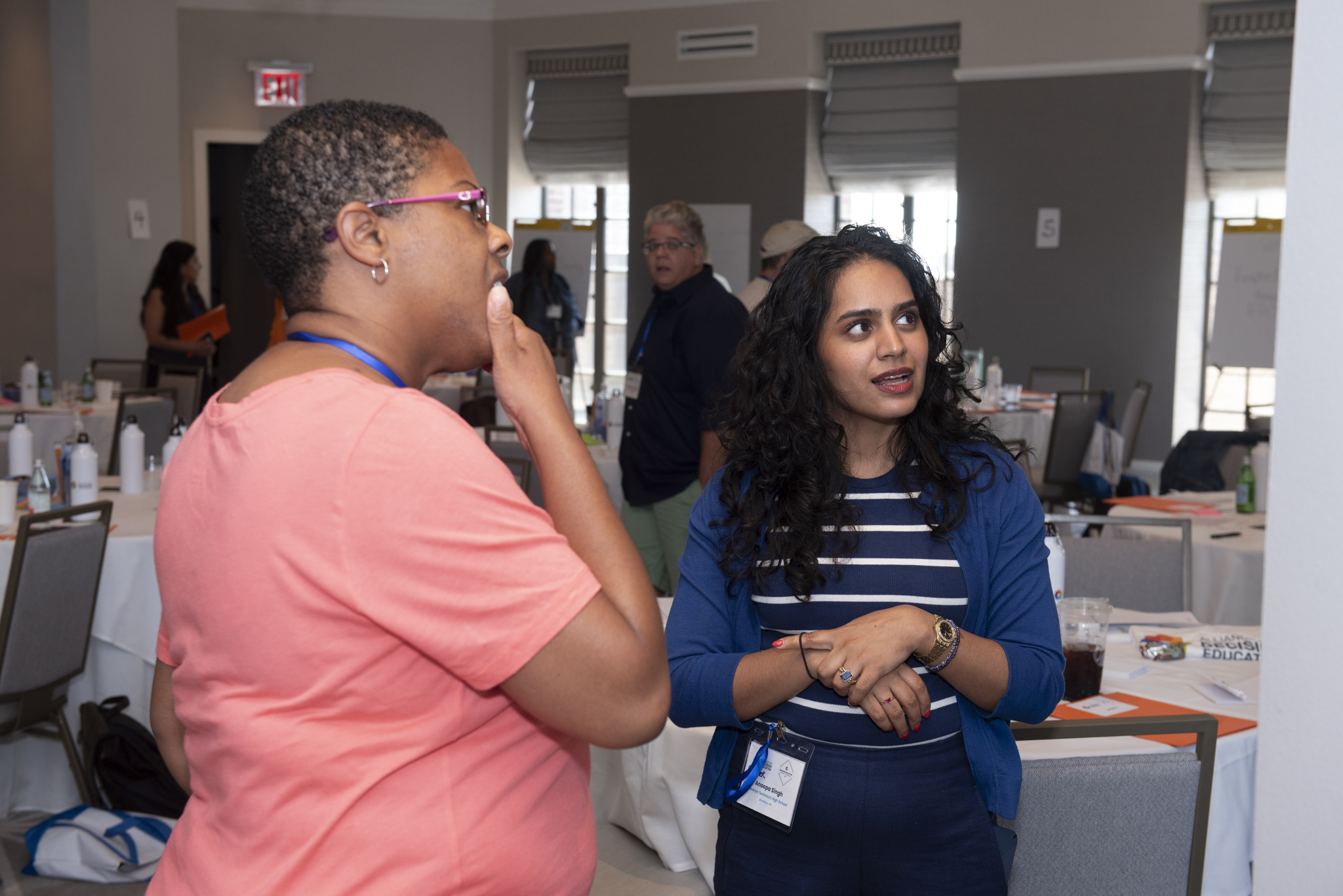 Teachers engage in a discussion during an event.